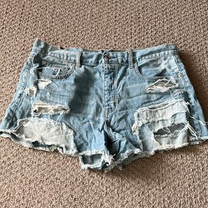 “Festival” distressed denim shorts. Button closure, size 14